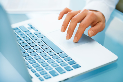 Close-up of hand woman using a laptop computer