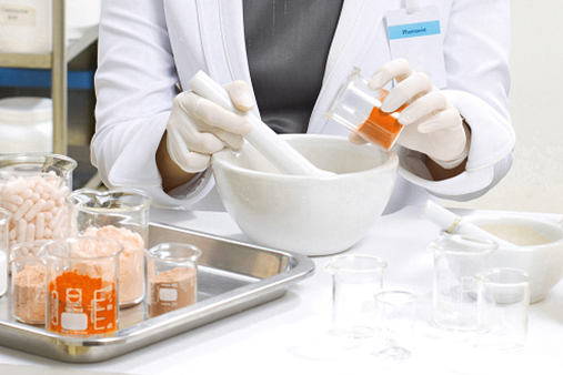 Pharmacist preparing medication with mortar and pestle